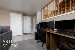 Home office featuring light carpet