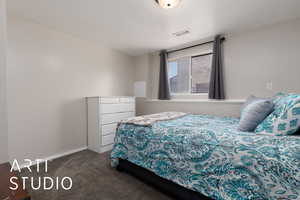 Carpeted bedroom featuring a textured ceiling