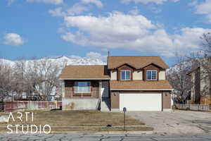 View of front of property featuring a mountain view and a garage