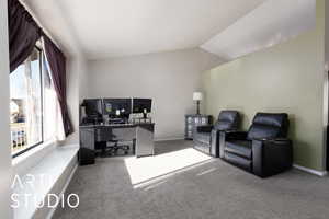 Office area featuring vaulted ceiling and carpet