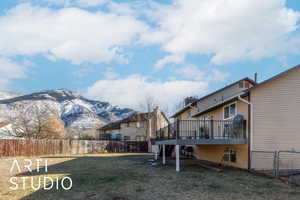 View of yard featuring a deck with mountain view