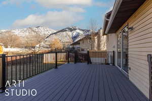 Snow covered deck featuring a mountain view