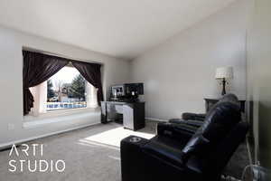 Interior space with lofted ceiling and carpet flooring