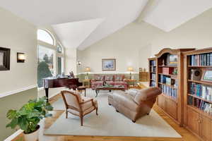 Living room featuring light hardwood / wood-style flooring and lofted ceiling with beams