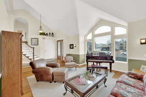 Living room featuring light hardwood / wood-style floors and high vaulted ceiling