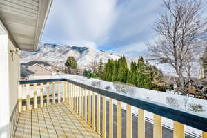 Snow covered back of property with a mountain view