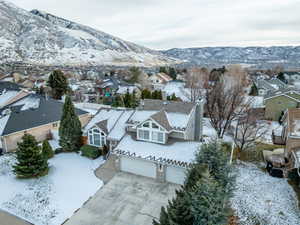 Snowy aerial view featuring a mountain view