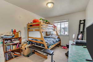 Bedroom with a textured ceiling