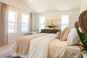 Bedroom featuring carpet flooring and lofted ceiling