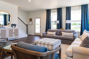 Living room with dark hardwood / wood-style flooring