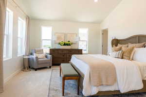 Carpeted bedroom with vaulted ceiling