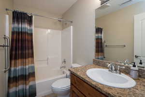 Full bathroom featuring vanity, toilet, and shower / bath combo