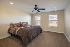 Bedroom featuring ceiling fan and carpet flooring