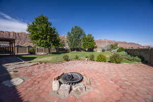 View of patio / terrace with a fire pit and a mountain view