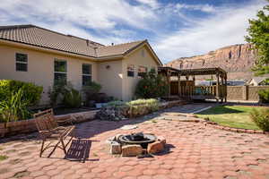 View of patio featuring a mountain view, a pergola, and a fire pit