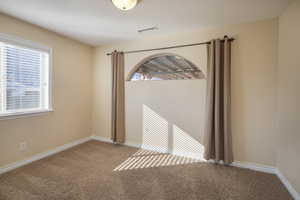 Unfurnished room featuring light colored carpet