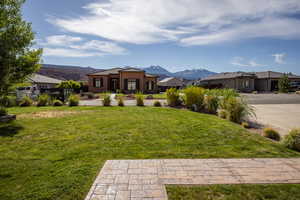 Exterior space featuring a mountain view and a front lawn