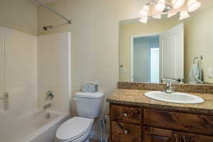 Full bathroom featuring shower / bathtub combination, toilet, and vanity