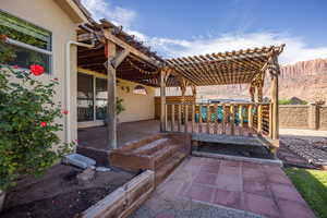 View of patio with a wooden deck