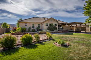 Rear view of house featuring a yard and a deck with mountain view