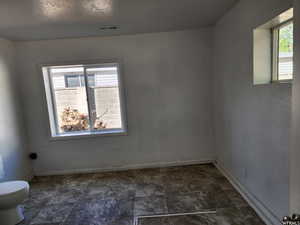 Empty room featuring a textured ceiling