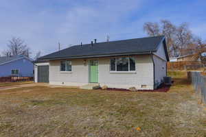 View of front of home featuring cooling unit and a front yard