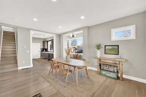 Dining space with light hardwood / wood-style flooring