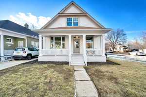 Bungalow-style home with covered porch and a front yard