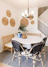 Dining area featuring breakfast area, wood-type flooring, and a chandelier