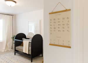 Bedroom with multiple windows and a crib