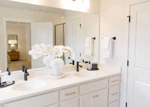 Bathroom featuring vanity and an enclosed shower