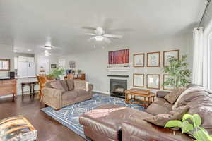 Living room featuring ceiling fan and dark hardwood / wood-style flooring