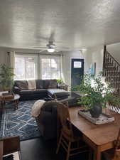 Living room featuring ceiling fan and wood-type flooring