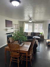 Dining space featuring ceiling fan and dark wood-type flooring