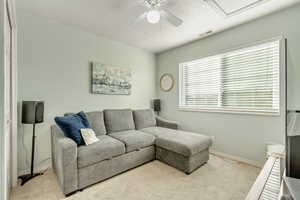 Living room featuring ceiling fan and light colored carpet