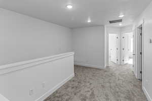 Hall with light colored carpet