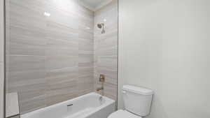 Bathroom featuring toilet and tiled shower / bath