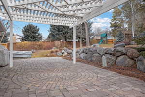 View of patio featuring a pergola and a playground