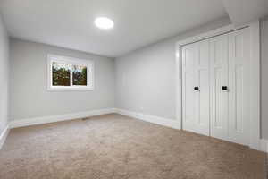 Unfurnished bedroom with carpet floors and a closet