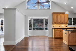 Kitchen featuring sink, decorative light fixtures, dark hardwood / wood-style floors, and ceiling fan