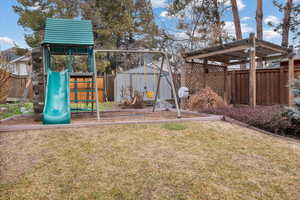 Exterior space featuring a storage unit and a yard