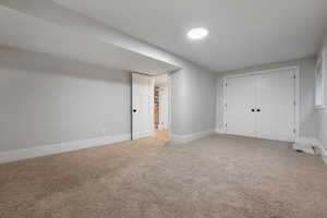 Unfurnished bedroom featuring a closet and carpet