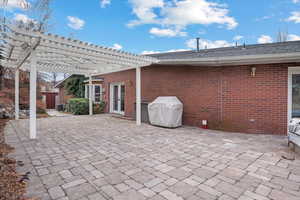 View of patio / terrace featuring central air condition unit, grilling area, and a pergola