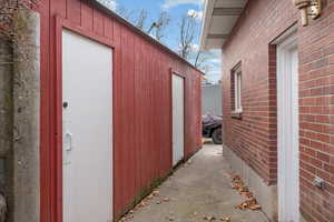 View of side of property featuring an outbuilding