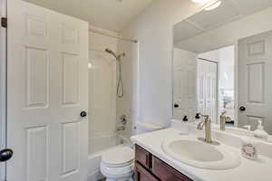 Full bathroom with shower / bathing tub combination, vanity, and toilet