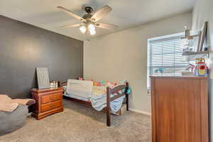 Bedroom with light colored carpet and ceiling fan