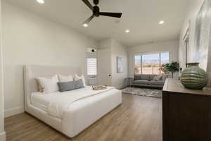 Bedroom with hardwood / wood-style floors and ceiling fan