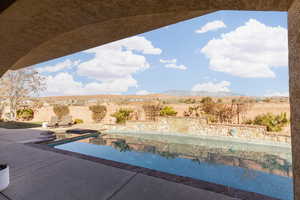 View of pool with a mountain view and a patio area