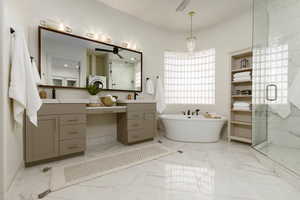 Bathroom with vanity and shower with separate bathtub