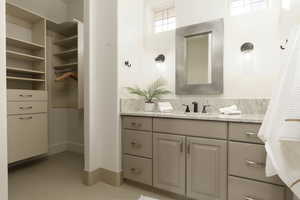 Bathroom featuring tile patterned flooring and vanity